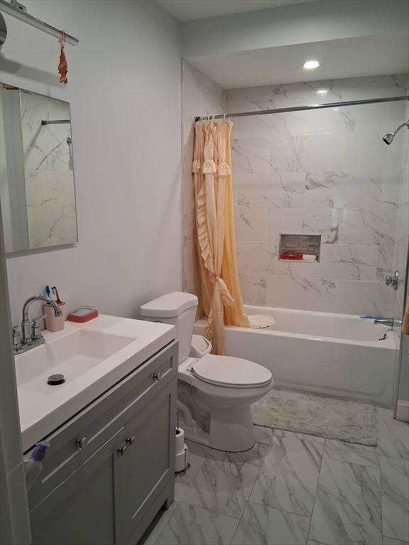 23 Barry St, Brockton, MA 02302 - full bathroom with shower / bath combo, toilet, vanity, and marble look tile flooring