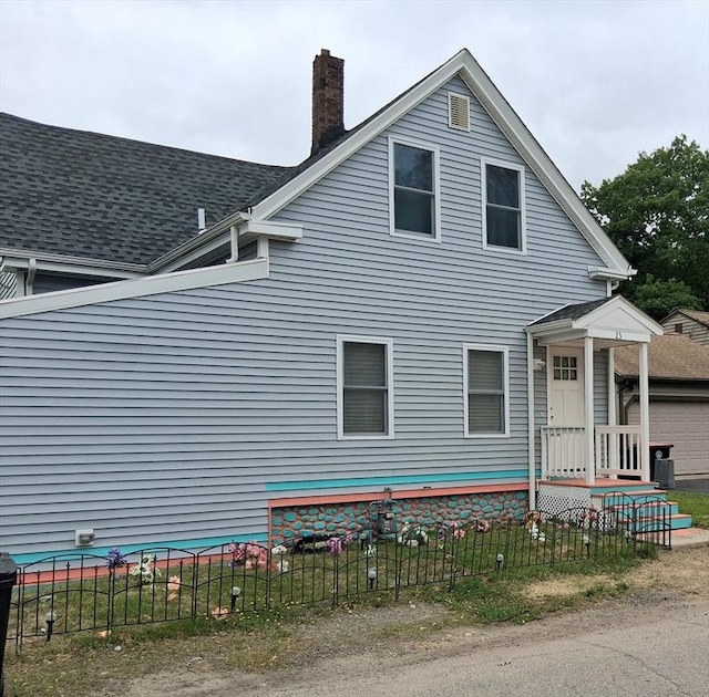 23 Barry St, Brockton, MA 02302 - view of home's exterior with a chimney and a garage
