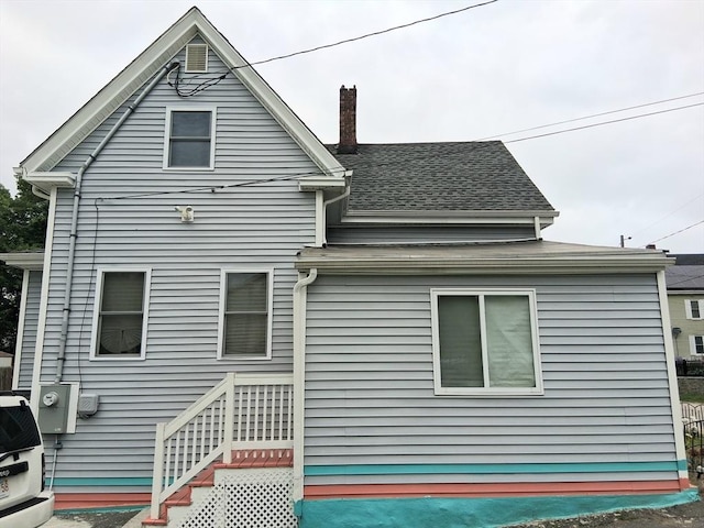 23 Barry St, Brockton, MA 02302 - rear view of house with a chimney and roof with shingles