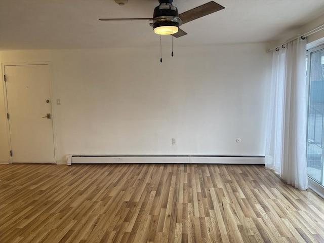 spare room with ceiling fan, baseboard heating, and light wood-style floors