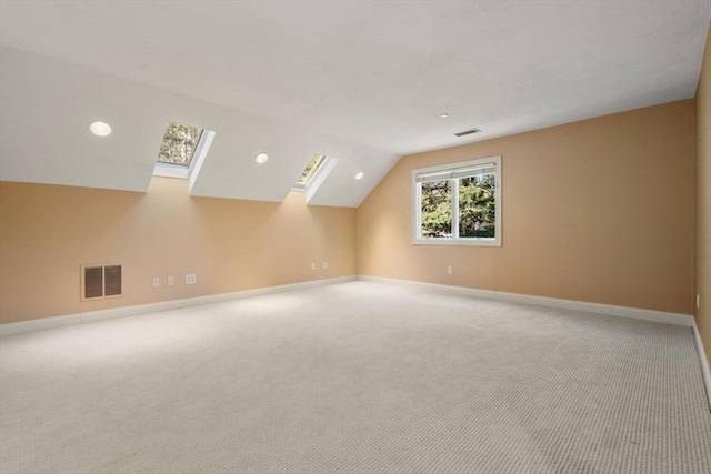 additional living space with lofted ceiling and light colored carpet