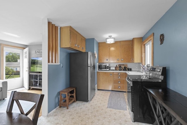 2 Wedgewood Rd, Dover, NH 03820 - kitchen with stainless steel appliances, brown cabinets, light floors, and light countertops