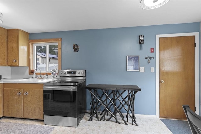 2 Wedgewood Rd, Dover, NH 03820 - kitchen featuring stainless steel electric range oven, light countertops, brown cabinetry, and light flooring