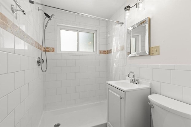 2 Wedgewood Rd, Dover, NH 03820 - bathroom featuring vanity, a tile shower, tile walls, and a wainscoted wall