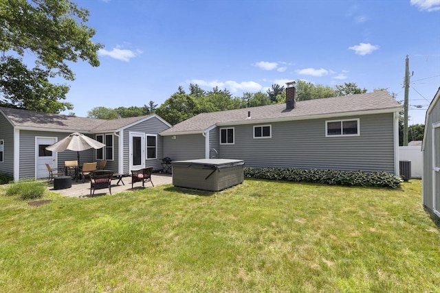 2 Wedgewood Rd, Dover, NH 03820 - rear view of house with a patio area, a chimney, a lawn, and a hot tub