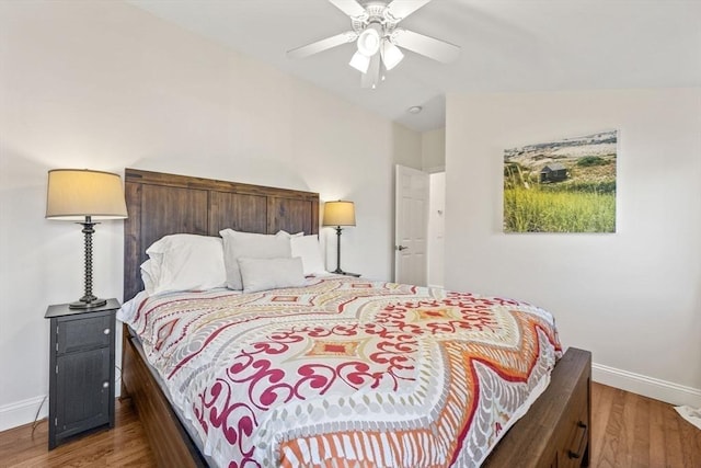 bedroom featuring lofted ceiling, ceiling fan, baseboards, and wood finished floors