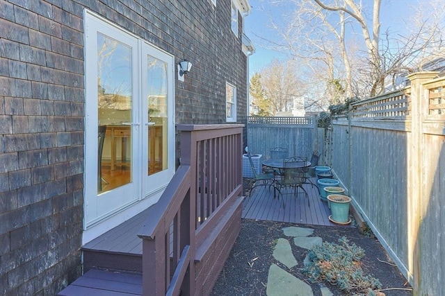 deck featuring french doors and a fenced backyard