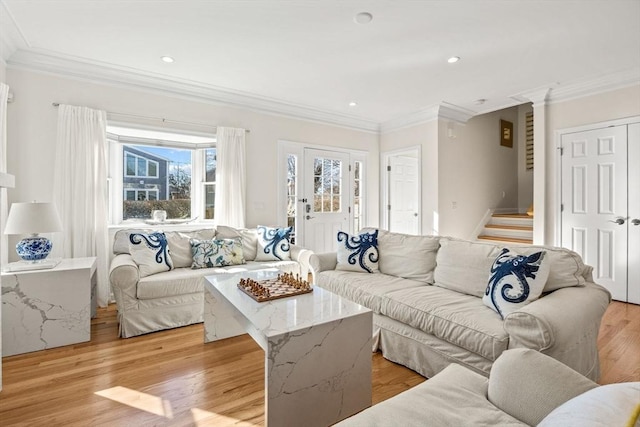 living area featuring recessed lighting, crown molding, stairway, and light wood finished floors