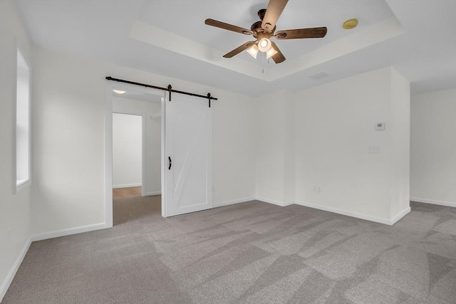 L-244 Doyle Ave, Winchendon, MA 01475 - carpeted spare room featuring a ceiling fan, a raised ceiling, and a barn door