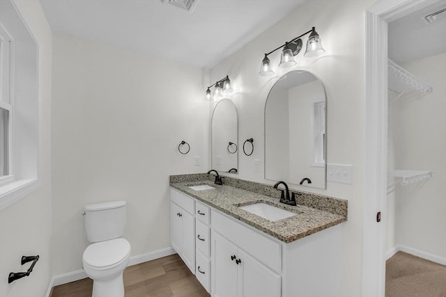 L-244 Doyle Ave, Winchendon, MA 01475 - full bath with double vanity, a walk in closet, and wood finished floors