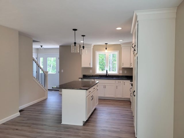 L-244 Doyle Ave, Winchendon, MA 01475 - kitchen with dark countertops, wood finished floors, recessed lighting, a center island, and white cabinets