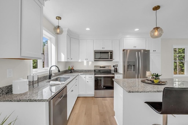 L-244 Doyle Ave, Winchendon, MA 01475 - kitchen featuring appliances with stainless steel finishes, white cabinetry, light wood finished floors, light stone countertops, and recessed lighting