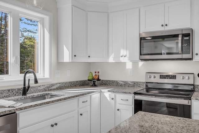 L-244 Doyle Ave, Winchendon, MA 01475 - kitchen with appliances with stainless steel finishes, white cabinets, and light stone countertops