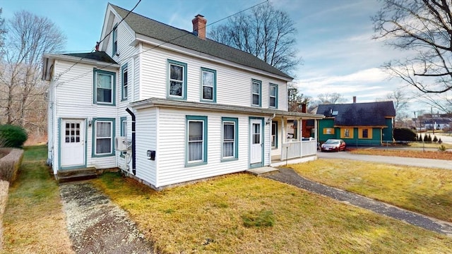 view of front of property with a porch and a front yard