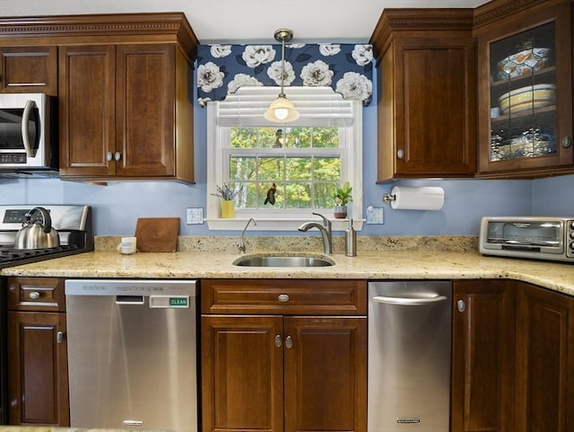 10 Robinhood Rd, Tyngsborough, MA 01879 - kitchen featuring appliances with stainless steel finishes, a sink, glass insert cabinets, and light stone counters
