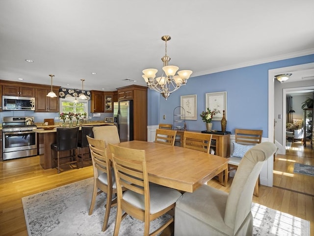 10 Robinhood Rd, Tyngsborough, MA 01879 - dining area with a chandelier, light wood finished floors, ornamental molding, and recessed lighting