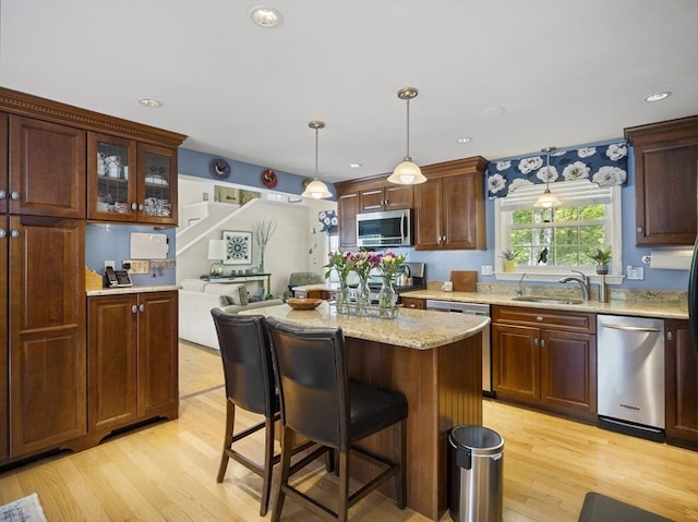 10 Robinhood Rd, Tyngsborough, MA 01879 - kitchen with appliances with stainless steel finishes, a sink, light wood-type flooring, a kitchen bar, and recessed lighting