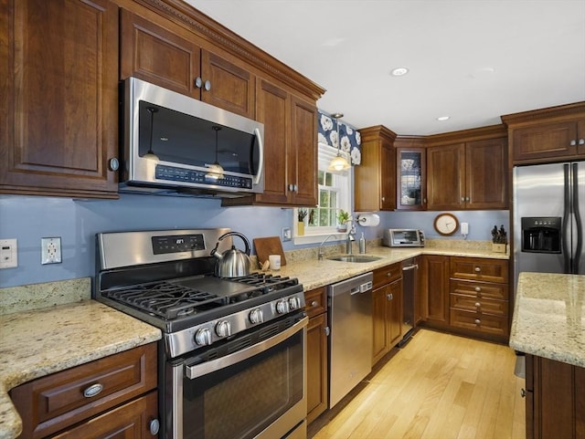 10 Robinhood Rd, Tyngsborough, MA 01879 - kitchen featuring appliances with stainless steel finishes, a sink, light wood-type flooring, light stone counters, and recessed lighting