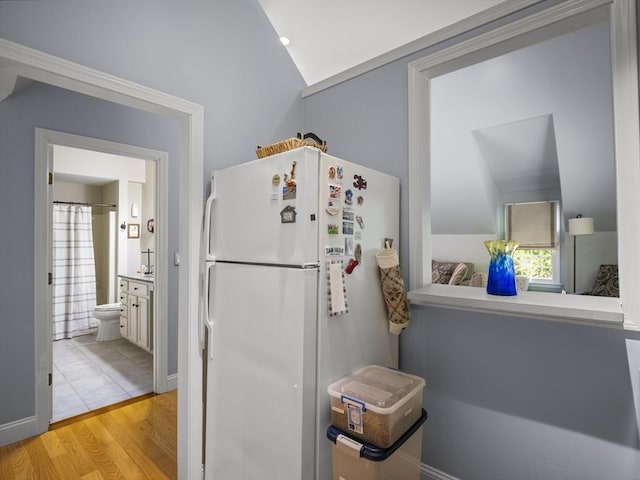 10 Robinhood Rd, Tyngsborough, MA 01879 - kitchen with freestanding refrigerator, light wood-style floors, vaulted ceiling, and healthy amount of natural light