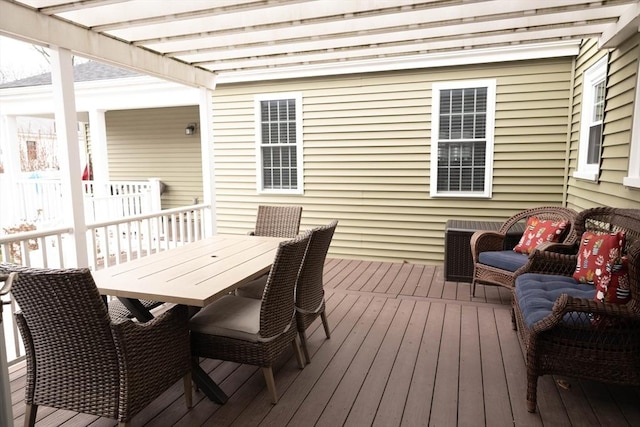 deck featuring outdoor dining area and a pergola