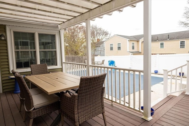 deck featuring a fenced in pool, outdoor dining area, and a fenced backyard