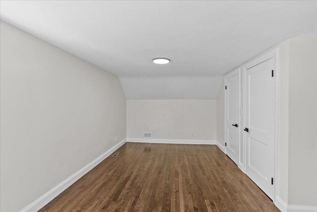 7 Curran Ter, Randolph, MA 02368 - spare room featuring dark wood-type flooring, baseboards, and lofted ceiling