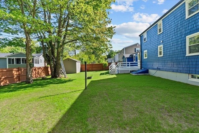 7 Curran Ter, Randolph, MA 02368 - view of yard featuring a storage unit, an outdoor structure, and a wooden deck