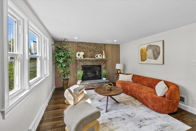 7 Curran Ter, Randolph, MA 02368 - living room with wood finished floors, baseboards, a brick fireplace, and recessed lighting
