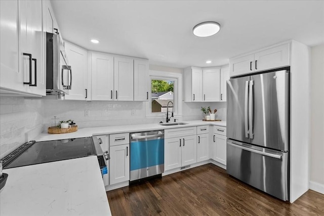 7 Curran Ter, Randolph, MA 02368 - kitchen featuring stainless steel appliances, a sink, tasteful backsplash, dark wood-style floors, and white cabinets