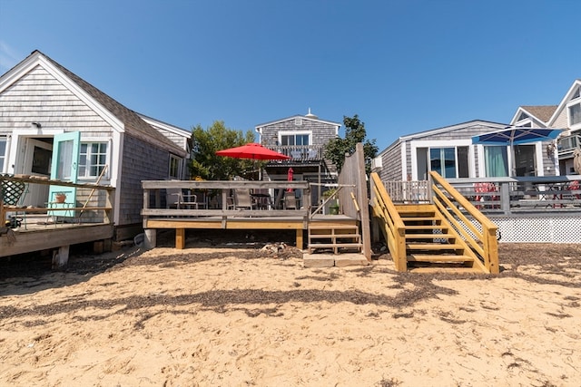 back of property with a wooden deck