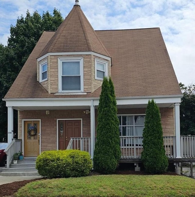 view of front facade with covered porch and a front lawn