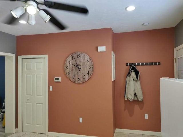 tiled foyer with ceiling fan