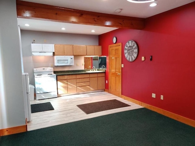 kitchen featuring white appliances, light wood-type flooring, beam ceiling, and sink