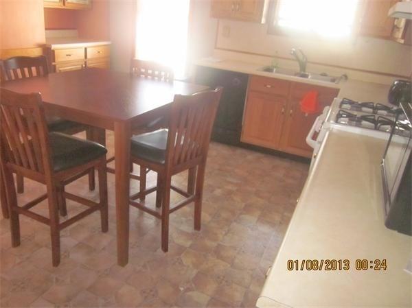 kitchen featuring exhaust hood, white range with gas stovetop, and sink