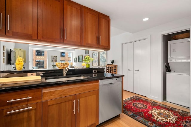 80 Broad St Unit 1002, Boston, MA 02110 - kitchen with stacked washer / dryer, stainless steel dishwasher, brown cabinetry, and a sink