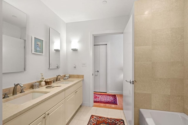 80 Broad St Unit 1002, Boston, MA 02110 - bathroom featuring a sink, a bathing tub, double vanity, and tile patterned floors