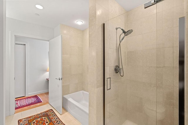 80 Broad St Unit 1002, Boston, MA 02110 - bathroom with a stall shower, tile patterned floors, and a garden tub
