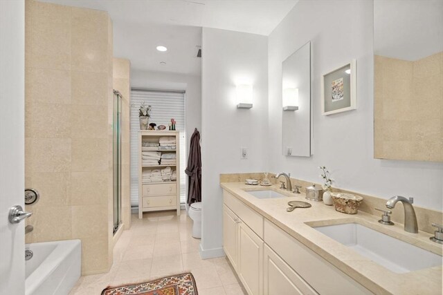 80 Broad St Unit 1002, Boston, MA 02110 - bathroom featuring a shower stall, tile patterned flooring, toilet, and a sink