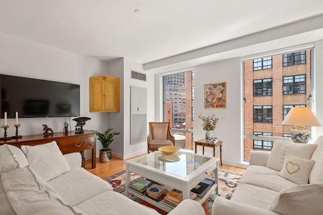 80 Broad St Unit 1002, Boston, MA 02110 - living room with baseboards, a wealth of natural light, light wood finished floors, and visible vents