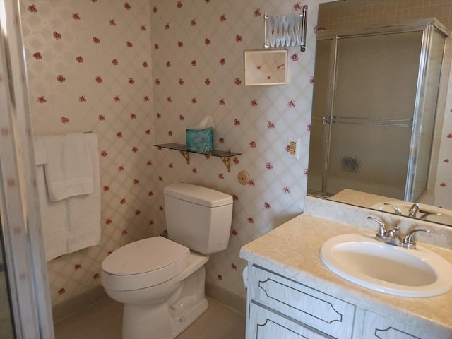 bathroom with vanity, tile patterned floors, a stall shower, and toilet