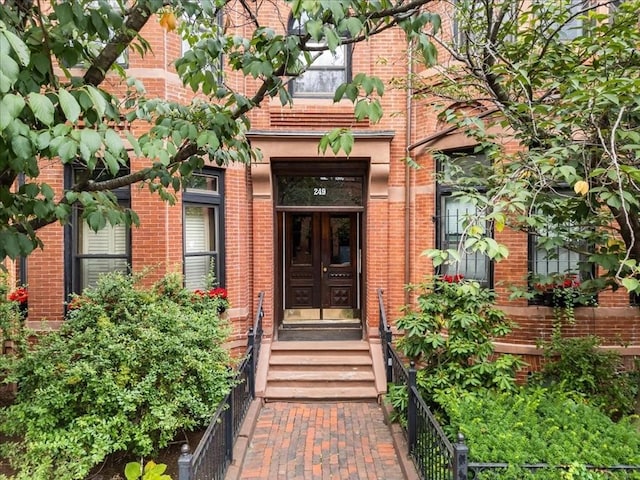 property entrance featuring brick siding