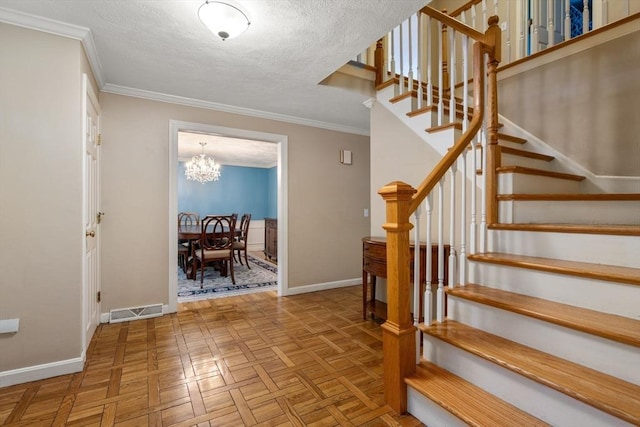 stairway with visible vents, crown molding, a textured ceiling, and baseboards