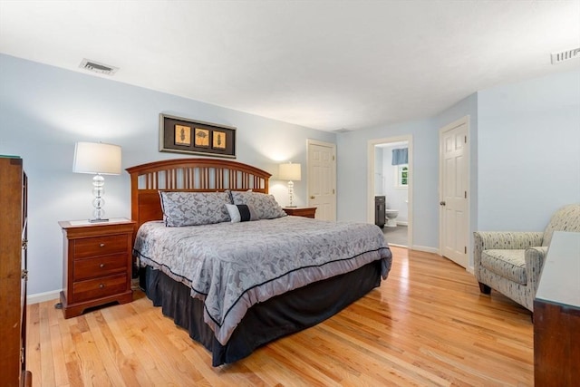 bedroom featuring visible vents, light wood-style flooring, and baseboards