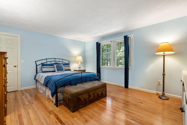 bedroom featuring light wood-style flooring and baseboards