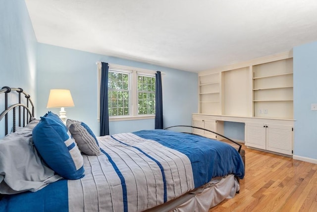 bedroom with light wood-style flooring and baseboards