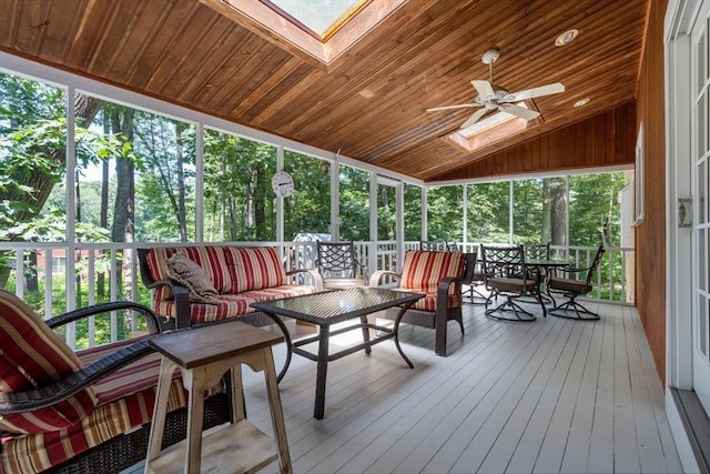 sunroom with lofted ceiling with skylight, wood ceiling, and ceiling fan