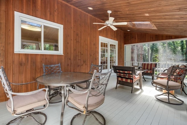 sunroom with lofted ceiling with skylight, wood ceiling, and a ceiling fan