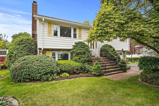 12 Cassidy Dr, Woburn, MA 01801 - view of front of home with a chimney and a front yard