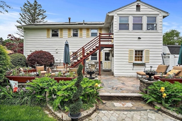 12 Cassidy Dr, Woburn, MA 01801 - back of property with stairs and a patio area