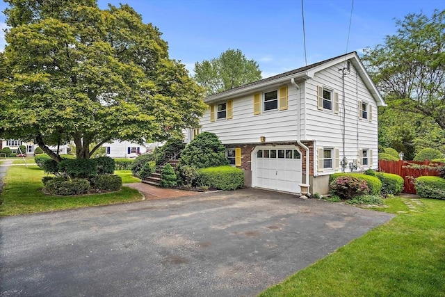 12 Cassidy Dr, Woburn, MA 01801 - view of front of home featuring driveway, a garage, and brick siding